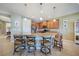 Modern kitchen featuring a granite island with seating and pendant lighting, great for entertaining or casual dining at 7346 Talon Bay Dr, North Port, FL 34287