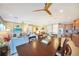 Bright and airy open-concept layout, connecting the living room, dining area, and kitchen, with modern ceiling fans at 7346 Talon Bay Dr, North Port, FL 34287