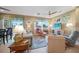Comfortable living room with large windows offering views of the lake, ideal for relaxing or entertaining guests at 7346 Talon Bay Dr, North Port, FL 34287