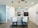Kitchen island with seating and gray cabinets with stainless steel appliances at 8858 Tuscany Isles Dr, Punta Gorda, FL 33950