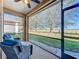 Relaxing screened lanai with comfortable seating and a picturesque view of the open field at 8858 Tuscany Isles Dr, Punta Gorda, FL 33950