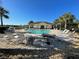 Relaxing pool area with chairs, tables, and a clear blue sky above at 8858 Tuscany Isles Dr, Punta Gorda, FL 33950