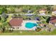 Aerial view of a community pool with lounge chairs and lush landscaping at 8858 Tuscany Isles Dr, Punta Gorda, FL 33950