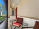 Seating area on a screened porch with red door visible at 8858 Tuscany Isles Dr, Punta Gorda, FL 33950