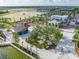 Landscaped park area with large trees, seating, play areas, and waterfront access in a modern community setting at 1022 S Lavina St, North Port, FL 34286
