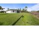 Large backyard features a lush lawn, privacy and is perfect for outdoor activities at 1022 S Lavina St, North Port, FL 34286
