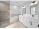 Bright bathroom featuring double sinks, a shower, a soaking tub, and modern fixtures at 1022 S Lavina St, North Port, FL 34286