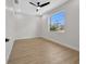 A bright bedroom features a ceiling fan and a large window at 1022 S Lavina St, North Port, FL 34286