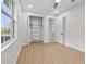 Wood-look floors and natural light enhance this bedroom with closet and adjoining door at 1022 S Lavina St, North Port, FL 34286