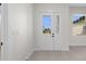 Bright foyer features a glass-paneled front door and view to the outdoors at 1022 S Lavina St, North Port, FL 34286