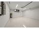 Large two car garage with epoxy flooring, overhead lighting, and space for storage and a workbench at 1022 S Lavina St, North Port, FL 34286