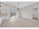 Open concept living area with sliding glass doors to lanai and eat-in kitchen at 1022 S Lavina St, North Port, FL 34286