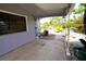 View of the back porch with palm tree decorations and an air conditioning unit at 21422 Mallory Ave, Port Charlotte, FL 33952