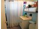 Bathroom featuring blue tiling, shower with curtain, and a vanity sink at 21422 Mallory Ave, Port Charlotte, FL 33952