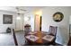 Inviting dining space with a round table set, decorative clock, and gray carpet at 21422 Mallory Ave, Port Charlotte, FL 33952