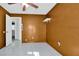 Small bedroom with brown walls and white tile floor at 256 Coblentz St, Port Charlotte, FL 33954