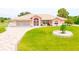 Single-story home with attractive landscaping and a large driveway at 256 Coblentz St, Port Charlotte, FL 33954