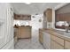 Galley kitchen with light wood cabinets and modern appliances at 256 Coblentz St, Port Charlotte, FL 33954