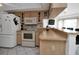 Kitchen features light wood cabinets, an island, and modern appliances at 256 Coblentz St, Port Charlotte, FL 33954