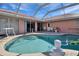Inviting kidney-shaped pool with screened enclosure at 256 Coblentz St, Port Charlotte, FL 33954