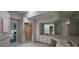Bathroom with double sinks, shower, and access to other rooms at 443 Madrid Blvd, Punta Gorda, FL 33950