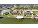 Aerial view of property and surrounding canal-front community at 15706 Viscount Cir, Port Charlotte, FL 33981