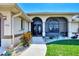 Front entrance with decorative archways and lush landscaping at 15706 Viscount Cir, Port Charlotte, FL 33981