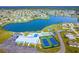 Aerial view of community with lake, pool, tennis courts, and clubhouse at 6287 Oriole Blvd, Englewood, FL 34224