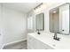 Modern bathroom with double vanity, updated fixtures, and large mirrors at 6287 Oriole Blvd, Englewood, FL 34224