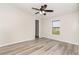 Well-lit bedroom featuring wood-look floors and a ceiling fan at 6287 Oriole Blvd, Englewood, FL 34224