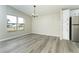 Bright dining room with gray vinyl flooring and chandelier at 6287 Oriole Blvd, Englewood, FL 34224