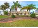 Single-wide home with gray and white exterior, wooden deck, and palm trees at 6287 Oriole Blvd, Englewood, FL 34224