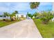 Single-wide home with light gray and white exterior, wooden deck, and landscaped yard at 6287 Oriole Blvd, Englewood, FL 34224