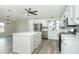 Modern kitchen with white cabinets, stainless steel appliances, and island at 6287 Oriole Blvd, Englewood, FL 34224