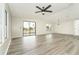 Spacious living room with gray vinyl flooring and sliding glass doors at 6287 Oriole Blvd, Englewood, FL 34224