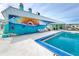 Community pool with ocean-themed mural and lounge chairs at 6287 Oriole Blvd, Englewood, FL 34224