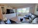 Living room with leather couches and built-in entertainment center at 2437 Harbor Blvd # 219, Port Charlotte, FL 33952