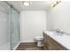 Modern bathroom with walk-in shower, single vanity, and marble countertop at 1080 Bal Harbor Blvd # 1C, Punta Gorda, FL 33950