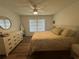 Main bedroom with a dresser, large bed, and ceiling fan at 1080 Bal Harbor Blvd # 1C, Punta Gorda, FL 33950