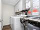 Laundry room with washer, dryer, and overhead cabinets at 1080 Bal Harbor Blvd # 1C, Punta Gorda, FL 33950