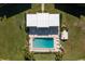 Community pool with surrounding patio furniture and lawn at 1080 Bal Harbor Blvd # 1C, Punta Gorda, FL 33950