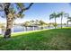 Waterfront property with lush lawn and tropical trees at 1080 Bal Harbor Blvd # 1C, Punta Gorda, FL 33950