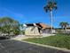 Landscaped entrance with a stone building, palm trees, and a well-maintained garden, welcoming visitors at 13468 Romford Ave, Port Charlotte, FL 33981