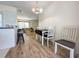 Inviting dining area with a stylish table set next to a modern kitchen, leading into the comfortable living room at 13468 Romford Ave, Port Charlotte, FL 33981