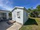 A well-maintained shed providing extra storage space, set against a backdrop of a green lawn and blue sky at 13468 Romford Ave, Port Charlotte, FL 33981