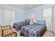 Bedroom with two twin beds, ceiling fan and wood bench at 523 Foxwood Blvd, Englewood, FL 34223