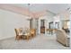 Casual dining area with a glass-top table and wicker chairs, offering a bright and airy space at 523 Foxwood Blvd, Englewood, FL 34223