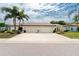 Front exterior of the home with three-car garage at 523 Foxwood Blvd, Englewood, FL 34223