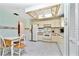Kitchen features white cabinets, tile floors, and breakfast nook at 523 Foxwood Blvd, Englewood, FL 34223