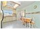 Kitchen boasts white cabinets, tile floors, and a breakfast nook at 523 Foxwood Blvd, Englewood, FL 34223
